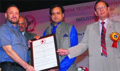 Dr Zora Singh, Chancellor of Desh Bhagat University, receives the award from Shashi Tharoor, Minister of State for Human Resource Development, in New Delhi. A Tribune photograph