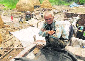 An old man surveys the flood damage caused in Gumthala village of Yamunanagar district on Wednesday