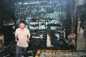 An official of the Union Bank of India sizes up the damage in fire in Karnal on Wednesday