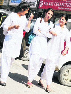 Students of Government Womens College walk on a roadside in Srinagar. The female literacy rate in the state is 56.43 per cent. 