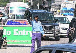 A traffic policeman reacts to a traffic violation in Srinagar. 