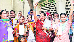 Women protest in front of the Deputy Commissioners office, against the district health authorities for closing a Central Town dispensary in Jalandhar on Wednesday