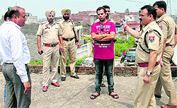 Police conducting inquiry at the residence where the couple lived; and (below) officials quiz the family members in Jalandhar on Wednesday