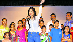 Bollywood actor Yuvika Chaudhary performs with children at Lovely Professional University for the promotion of her forthcoming film Enemmy near Jalandhar on Wednesday