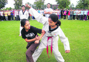 Girls participate in a self-defence training session during the NCC camp at Guru Nanak Khalsa College. 