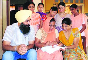 Representatives of an orphanage run by the Swami Ganga Nand Bhuriwale International Foundation at Talwandi Dham village with the newborn child.  