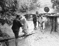 Members of the 63 Cavalry trekking team help marooned people at Mall village in Uttarkashi.