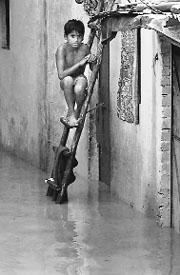A boy outside his house in New Delhi on Wednesday.