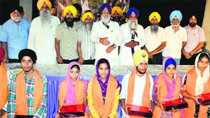 SGPC president Avtar Singh and Akal Takht Jathedar Gurbachan Singh (centre) felicitate children in Amritsar on Thursday. 