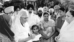 Residents take part in a signature campaign against the acquisition of SGPC land in Mohali on Thursday.