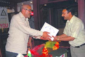 President of the Mussoorie Municipal Council felicitates a teacher at a function organised by the Rotary Club on Thursday