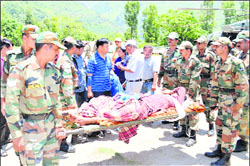 A sick woman rescued from the Darma valley by an Army helicopter brought to Sobla in Pithoragarh district on Thursday. Photo by writer 