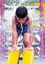 A child enjoys splashing around in water at Splash Park in Karnal. 