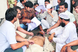 Bablu Qureshi, president, Minority Council, Punjab lies unconscious outside the Police Commissioner's office in Ludhiana on Thursday. Tribune photo: Himanshu Mahajan 
