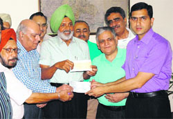 Members of the Amritsar Club, Services Club and Lumsdon Club hand over cheques for Rs 3 lakh to Deputy Commissioner Rajat Aggarwal in Amritsar on Friday as relief fund for those pilgrims who got stranded at Uttarakhand due to flash floods. Photo: Vishal Kumar