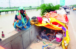 The flood-hit residents of Usmanpur stay at the roadside in northeast Delhi on Friday.