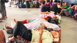 Pilgrims of the Char Dham Yatra, who were evacuated from calamity-hit areas, wait for trains to their destinations at Haridwar railway station on Friday. Tribune photo: Rameshwar Gaur
