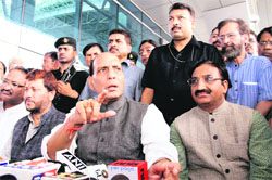 BJP National President Rajnath Singh addresses mediapersons at Jolly Grant Airport near Dehradun after a visit to Kedarnath on Thursday as former CM Ramesh Pokhriyal Nishank looks. Tribune photo: Vinod Pundir 