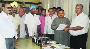 State BJP vice-president Rajiv Jain hands over a memorandum to SB Lohia, ADC, at the mini-secretariat in Sonepat on Friday. 