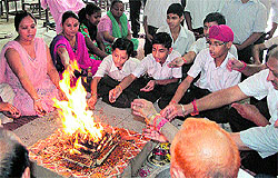 Schoolchildren and residents pray for the well-being of those trapped in Uttarakhand flash floods and landslides, in Jalandhar on Friday
