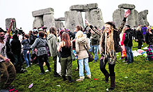 Revellers celebrate the summer solstice at the Stonehenge monument in southern England on Friday