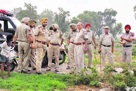 Policemen at the encounter site near Lalru on Saturday