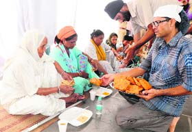 Pilgrims, who were rescued from flood-hit Gobind Ghat in Uttarakhand, being served langar in Chandigarh on Saturday