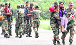 A family rescued from the Gaurikund area of Kedarnath being brought to Gauchar in Rudraprayag district on Saturday. Tribune photo: Vinod Pundir