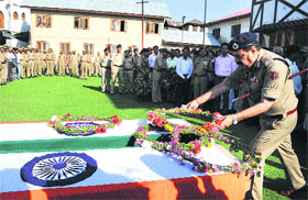 DGP Ashok Prasad lays a wreath at the coffins of policemen Mohammad Maqbool Mir of Pulwama and Nazir Ahmad of Kulgam, who were killed in a suspected militant attack, at District Police Lines in Srinagar on Saturday. CM Omar Abdullah and PDP president Mehbooba Mufti have condemned the killing. The ceremony was attended by adviser to the CM Qamar Ali Akhoon and Minister of State for Animal Husbandry Nazir Ahmad Khan Gurezi.