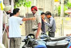 Policemen question shopkeepers at Aarti Chowk in Ludhiana.