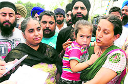 Gurpreet Kaur from Hoshiarpur (holding her child) at the ISBT-43 in Chandigarh on Saturday