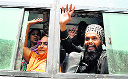 Joyous pilgrims wave from a bus that ferried them from disaster-hit Uttarakhand to Punjab, in Patiala on Satruday