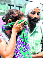 A pilgrim breaks down upon her arrival from Hemkund Sahib in Patiala on Saturday