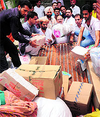 Workers of the Youth Congress load relief material on a truck at Congress Bhawan in Sector 35, Chandigarh, on Sunday