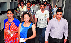 Students come out of an examination centre at the PU after appearing in the law entrance exam