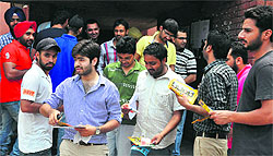 Members of a student organisation distribute pamphlets among students