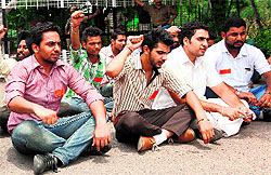 PUSU activists stage a dharna outside the office of the PU Vice-Chancellor on Sunday