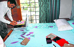 An official inspects a room at the house where the theft took place in Sector 12-A, Panchkula, on Sunday
