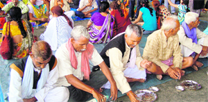 Stranded pilgrims take food at a relief camp in Haridwar on Sunday. 