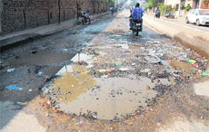 A damaged road with sewage lying in the open, linking Ladowali with Gurunanakpura, which has become a death trap for motorists in Jalandhar.