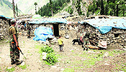 Army personnel inspect the area near the camp on Sunday