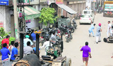 Politicians supporters pelt one another with stones during a clash at New Shakti Nagar in Ludhiana on Sunday; and (below right) a vehicle that was damaged in the clash.