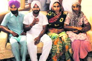Bohad Singh (in white turban) along with other rescued pilgrims in Muktsar on Sunday.