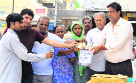 Helping hands: Residents of Paras Ram Nagar collect money and relief material for the victims of floods in Uttarakhand, in Bathinda on Monday.