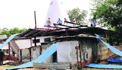 Enforcement staff pull down an illegal structure at a temple in Sector 10 on Monday. tribune photo