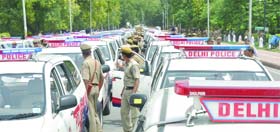 Delhi Police personnel check newly inducted PCR vans at India Gate in New Delhi on Monday