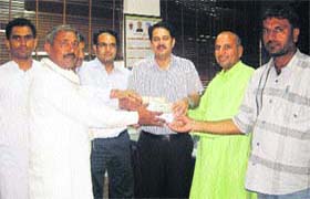 Sarpanches of Kalayat block in Kaithal district hand over Rs 1. 12 lakh in cash to Dinesh Singh Yadav, ADC, for the Uttarakhand flood victims on Monday
