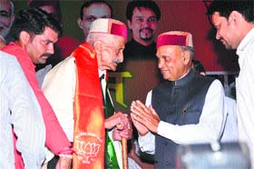 Former Chief Minister PK Dhumal honours a veteran BJP activist at a function in Hamirpur on Monday