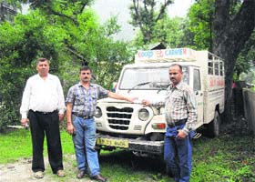 Police and forest officials with the impounded vehicle in Chamba on Monday