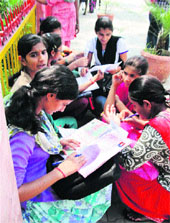 Candidates fill admission forms for various graduation courses in a Gurgaon college.